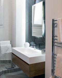 a bathroom with a white sink and a mirror at Casa Vacanze Umberto I in Naples