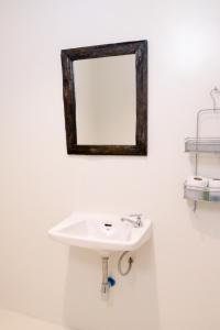 a bathroom with a sink and a mirror on the wall at 7 Rooms Kohchang in Ko Chang