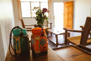 two backpacks sitting on a table in a living room at 7 Rooms Kohchang in Ko Chang
