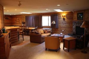 a living room with a couch and a table and a kitchen at The Lodge at Crooked Lake in Siren