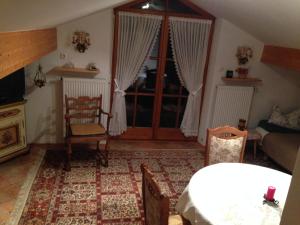 a living room with a bed and a fireplace at Gästehaus Färbinger in Bayerisch Gmain