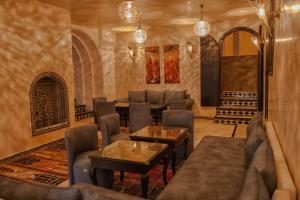 a living room with couches and a table at Lina Ryad & Spa in Chefchaouene