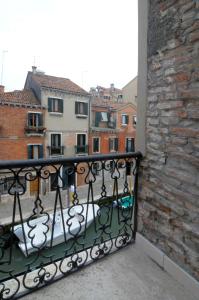 a balcony with a iron railing and a brick building at Ca' dell' Artista with Balcony and Terrace in Venice