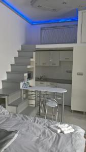 a room with a table and chairs and stairs at Széchenyi Apartman Miskolc belvárosban in Miskolc