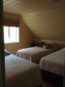 a room with two beds and a window at La Bohème in Frampton