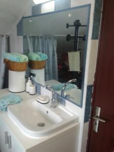 a bathroom with a sink and a mirror at Gabi Guesthouse in Constanţa