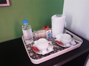 a tray filled with dishes and a bottle of water at Hotel Emblemático Arucas in Arucas
