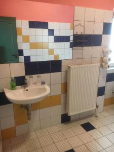baño con lavabo y radiador en Roland Motel, en Orosháza