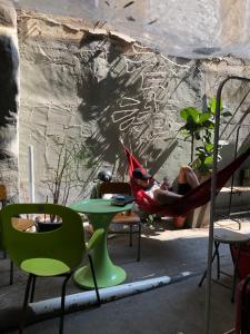 a man laying in a hammock in a tent at Wontonmeen in Hong Kong
