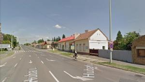 a person riding a bike down a street at Roland Motel in Orosháza