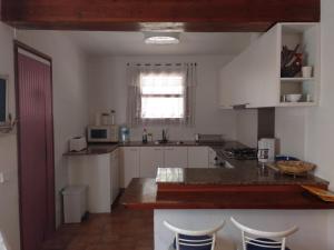 a kitchen with white cabinets and a counter top at Casa Estany in L'Ametlla de Mar