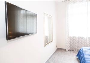 a living room with a flat screen tv on a wall at Gru House in Grugliasco