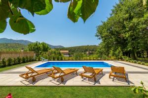 a group of chairs and a swimming pool at Holiday Home Gata 7 in Gata