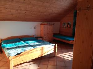 a bedroom with a wooden bed in a cabin at Blockhaus Royer in Ramsau am Dachstein
