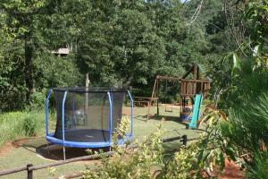 um parque infantil com um trampolim e um baloiço em Sabie Star em Sabie