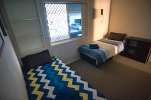 a bedroom with a bed and a window at Mount Gravatt Guesthouse in Brisbane