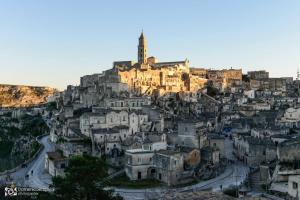 a city on top of a mountain with a building at Il Re degli Scalzi in Matera