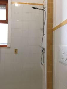 a shower with a shower head in a bathroom at Il Girasole in Torre dell'Orso +25 photos