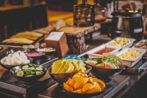 a buffet with bowls of different types of fruits and vegetables at Hotel Kea by Keahotels in Akureyri