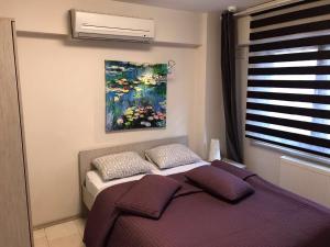 a bedroom with a bed and a painting on the wall at Bursa Park Apart Hotel in Bursa