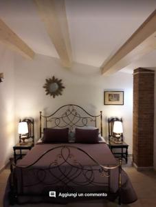 a bedroom with a bed with two lamps and a mirror at Villa Chiarenza Maison d'Hotes in Giardini Naxos