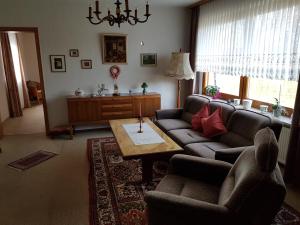 una sala de estar con un sofá y una mesa en Ferienwohnung, Monteurwohnung "Strunde", en Bergisch Gladbach