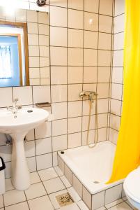 a bathroom with a tub shower and a sink at Apartment Ohrid Forever in Lagadin