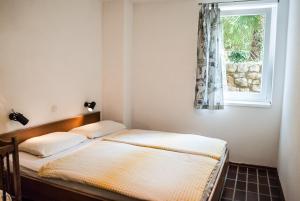 two twin beds in a room with a window at Apartment Ohrid Forever in Lagadin