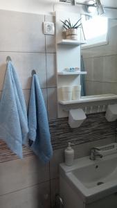 a bathroom with blue towels and a sink at Apartments Mory in Kornić +51 photos