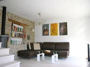 a living room with a couch and a brick wall at Villa Kentic in Buzet
