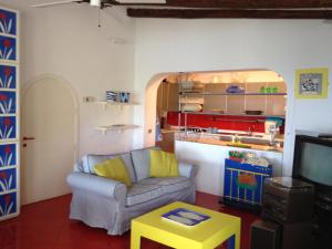 a living room with a couch and a tv at La Bouganville in Giglio Porto