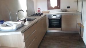 a kitchen with a sink and a stove at Twins Farm in Cormòns