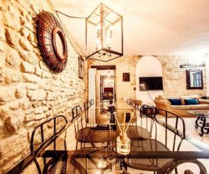 a living room with a stone wall and a chandelier at Maison Marais in Paris