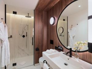 a bathroom with a sink and a mirror at H10 Madison 4* Sup in Barcelona