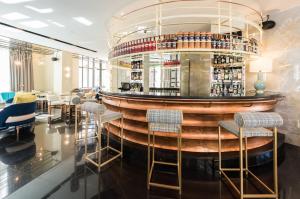 a bar in a restaurant with chairs and tables at Vincci Capitol in Madrid +54 photos