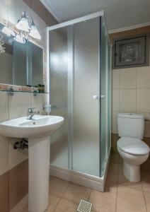 a bathroom with a shower and a sink and a toilet at Milos Apartments in Adamas +25 photos