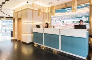 two women sitting at a reception desk in a building at Vincci Capitol in Madrid
