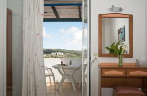 a bathroom with a window and a sink and a mirror at Contaratos Holiday Lettings 3 in Livadi