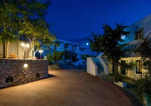 a driveway in front of a building at night at Contaratos Holiday Lettings 3 in Livadi