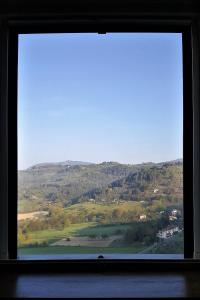 a window with a view of a mountain at La Casa nel Borgo in Torre Orsina