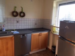 a kitchen with a stainless steel refrigerator and a sink at FeWo und Zimmer Egert in Hattenheim