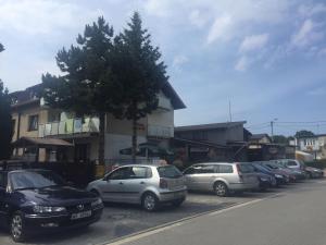 a row of cars parked on the side of a street at Latarnik in Karwia