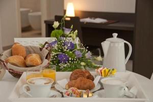 a tray with breakfast foods and drinks on a table at Il Marlo Suite & Breakfast in Marina di Carrara