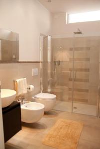 a bathroom with a shower and a toilet and a sink at Il Marlo Suite & Breakfast in Marina di Carrara