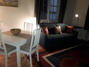 un soggiorno con un tavolo e un divano di Cosy Little House a Genova Altre 16 foto