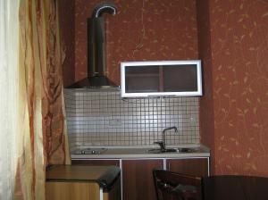 a small kitchen with a stove and a sink at Comfortel ApartHotel in Odesa +34 photos