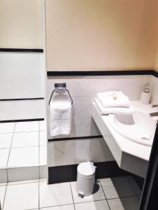 a bathroom with a sink and a toilet at Hotel de France in Bergerac