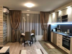 a kitchen and dining room with a table and chairs at Apartments Park Place in Sandanski