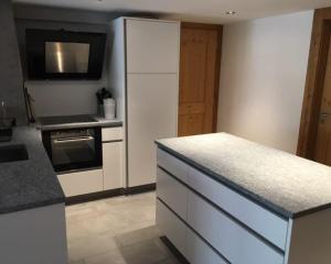 a kitchen with a white refrigerator and a counter top at Chalet Le Trient in Trient