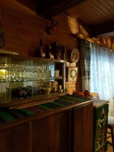 a kitchen with a counter with glasses on a shelf at Ptaszorowka in Szczyrk